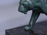statue of a panther on a marble base on a white background