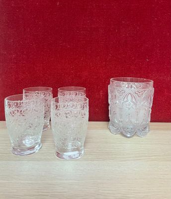 three glasses sitting on a table next to a red wall