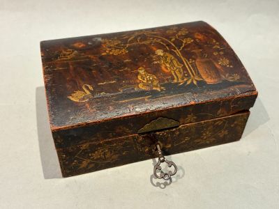 a small wooden box with a lock on it