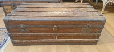 many old trunks sitting on the floor in a room