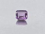 a purple amethorate stone on a white surface