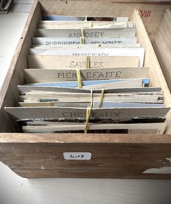 a wooden box with a bunch of papers in it