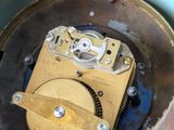 a close up of a clock inside of a wooden box