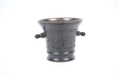 a black vase that is sitting on a white surface