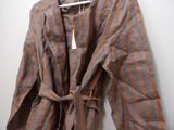 brown and orange striped robe hanging on a hanger on a wall