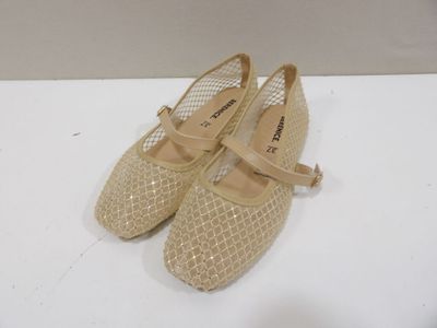 pair of beige shoes on a white surface with a white background