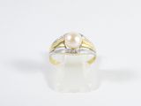an image of a pearl and diamond ring on a white surface