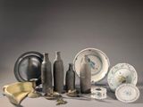 many different types of vases and plates on the table