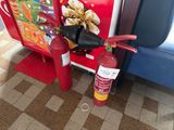a fire extinguisor next to a fire hydrant on the floor