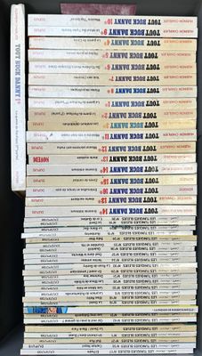 a lot of books that are stacked on top of each other