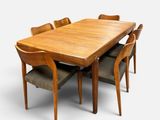 an image of a wooden table with six chairs around it