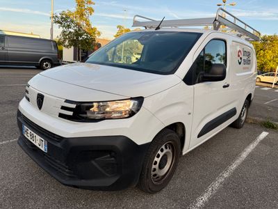 the white van is parked in a parking lot with other vehicles in the background