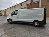 a white van parked in front of a building