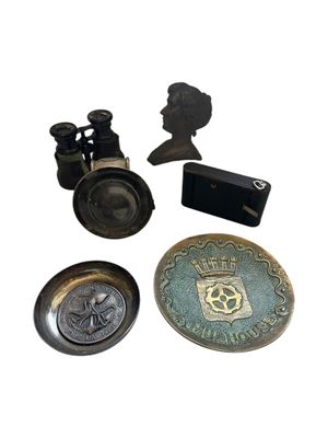 several antique brass objects including a pair of binoculars, a coin, and a box