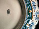 a close up of a plate with a flower design on it