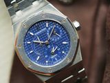 a close up of a watch with a blue dial
