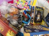 a basket full of toys and books on the floor