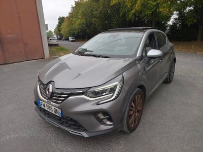 a grey car parked in a parking lot next to a building