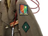 a brown jacket with a patch on it and a badge on it