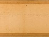 an old piece of paper with writing on it sitting on top of a table