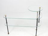 two tiered glass coffee table with brass legs and a glass top
