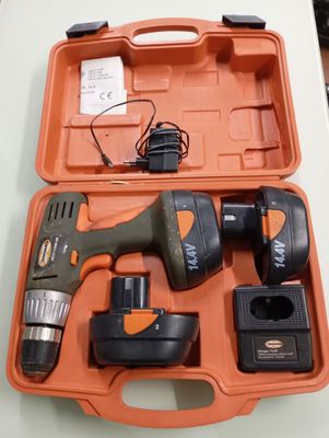 a cordless drill in a case on a table