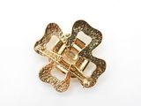 an image of a gold colored brooch with a flower on it