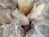 a bunch of bread wrapped in plastic bags on a table