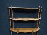 a wooden shelf that has three shelves on it