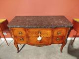 a marble top table with two chairs next to it