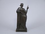 bronze statue of a woman holding a cigarette in her right hand