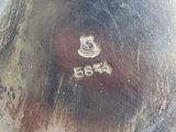 a close up of a silver plate on a table