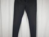 a pair of black jeans hanging on a white curtain