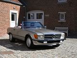 a silver car parked in front of a brick building