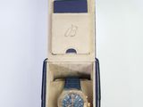 an image of a blue watch in a box on a white surface