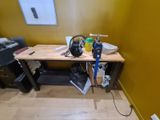 a desk with a camera and a printer on it in a room