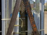 a wooden pole with a sign on it in front of a building