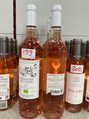 several bottles of wine are lined up on a counter