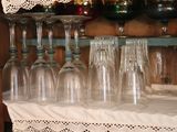 many wine glasses sitting on a table with a lace tablecloth