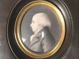 an old picture of a man in a suit and tie in a wooden frame