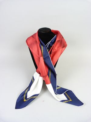 scarf on a mannequin stand with a red and blue scarf tied to it