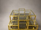 a set of four glass and brass coffee tables