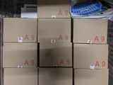 boxes stacked on top of each other in front of a brick wall
