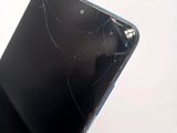 a broken cell phone with a broken screen on it