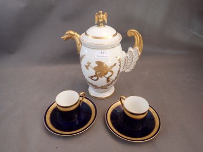 two cups and a teapot sitting on a table