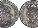 a silver coin with a crown on top of it