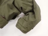 a pair of shoes and a jacket on a white surface