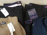 a lot of men ' s clothing on display in a store