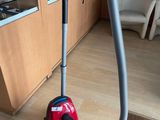 a vacuum that is on the floor in a room