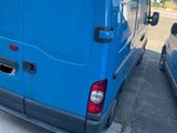 a blue van that is parked next to another blue van